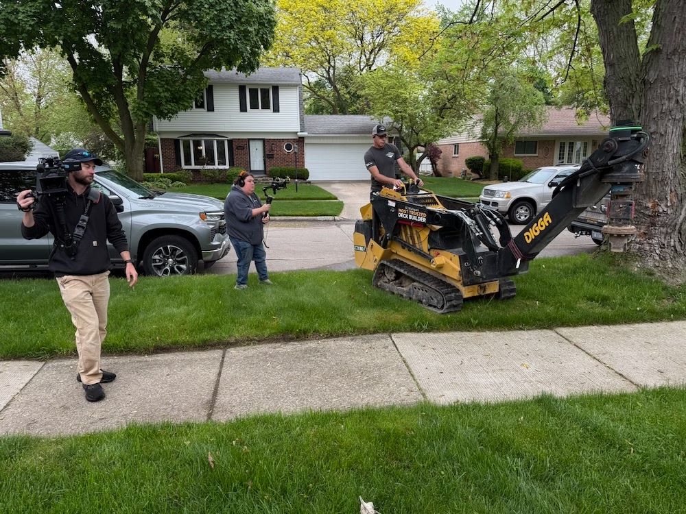 Camera crew filming a yard project